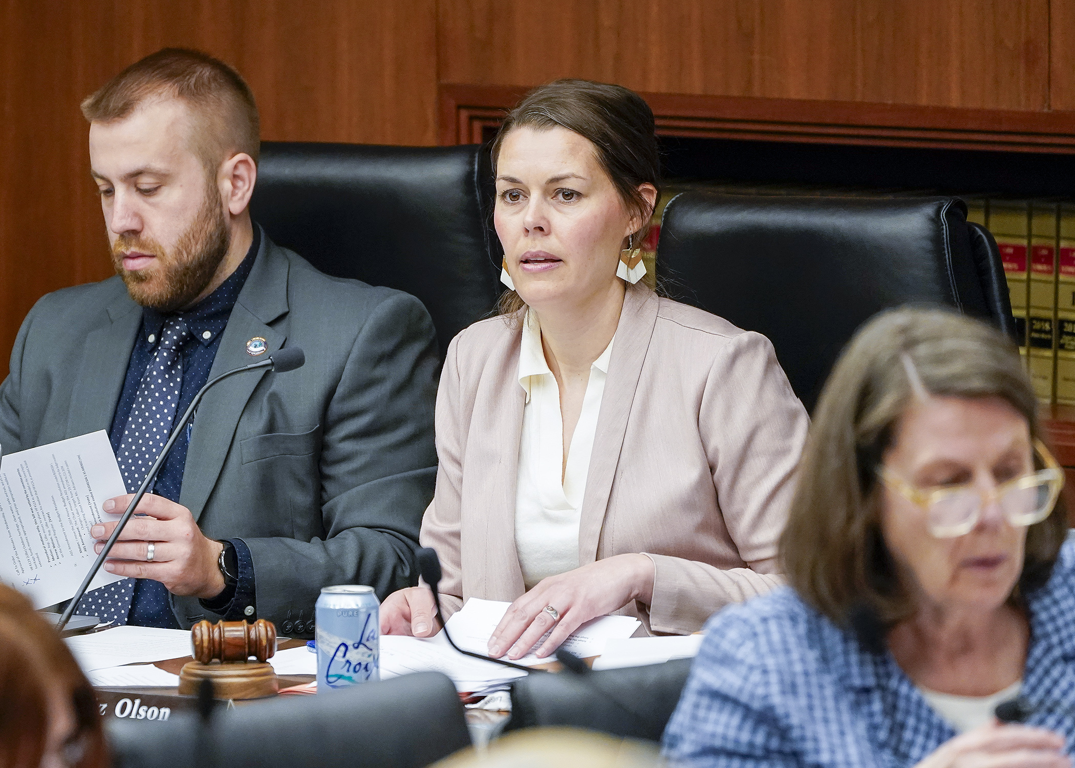 Rep. Liz Olson, chair of the House Ways and Means Committee, presides over a packed hearing room April 25. (Photo by Andrew VonBank)